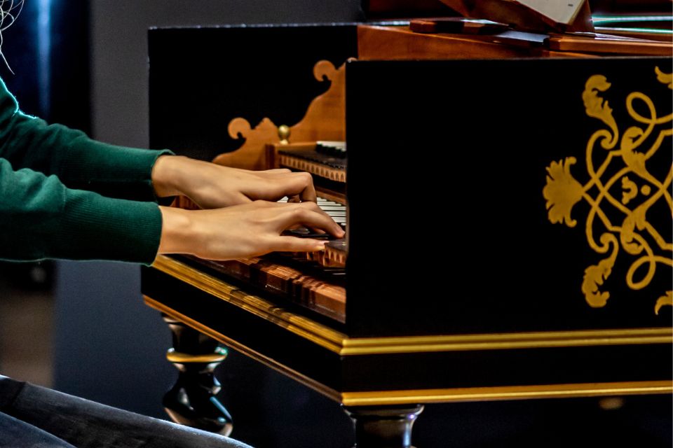 A close up of a pair of hands playing the harpsichord
