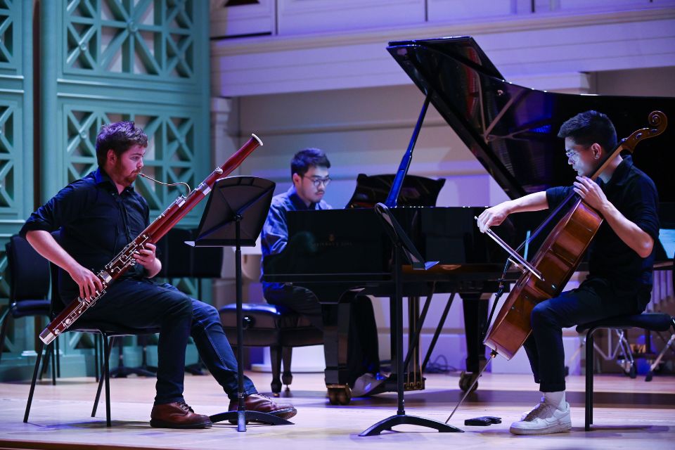 A cellist, bassoonist and pianist perform on stage