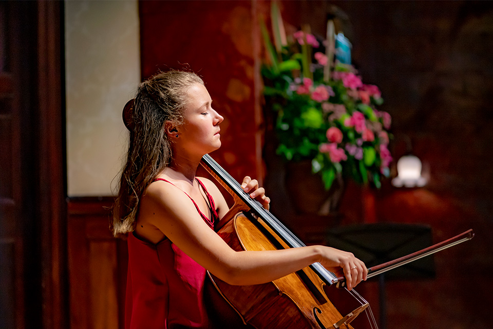 Clelia Le Bret looks down as she plays the cello