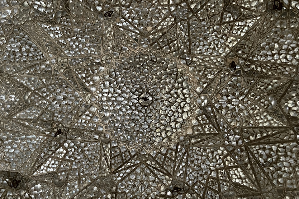 An elaborately tiled ceiling in shades of grey and silver