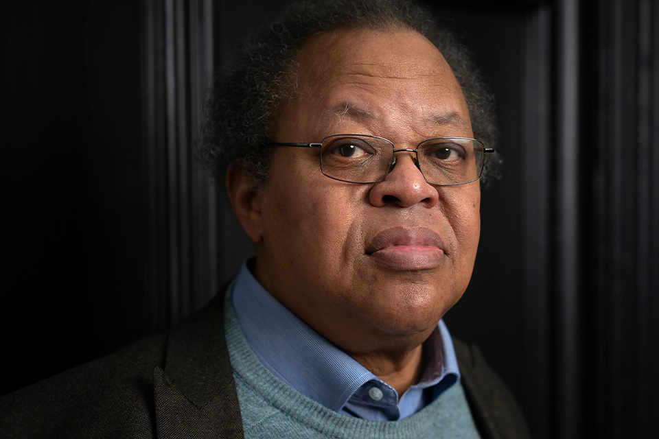 George Lewis wears a blue shirt and grey blazer