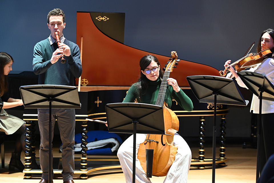 Three musicians perform historical instruments