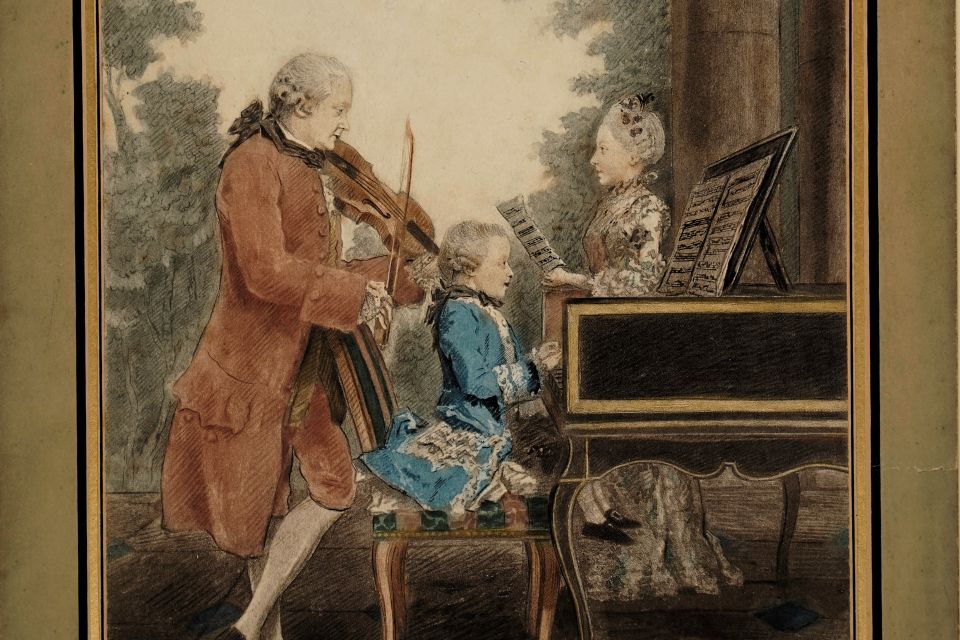 An old painting of a young Mozart playing the piano while his father plays the violin and mother watches
