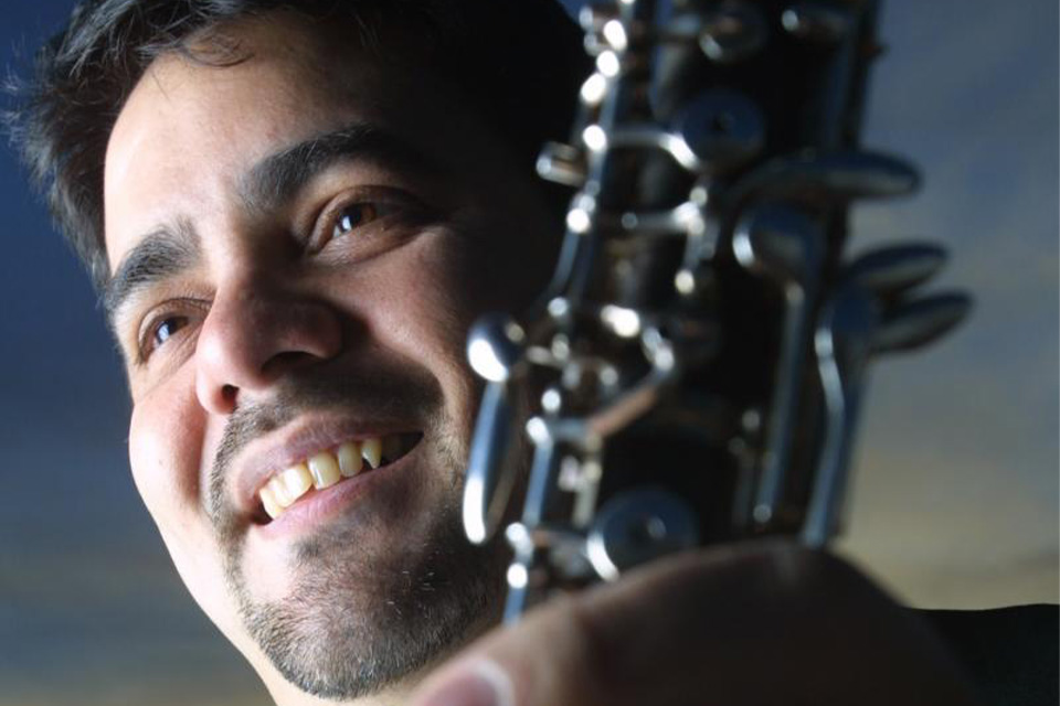 A close-up of Pedro Díaz smiling and looking downwards
