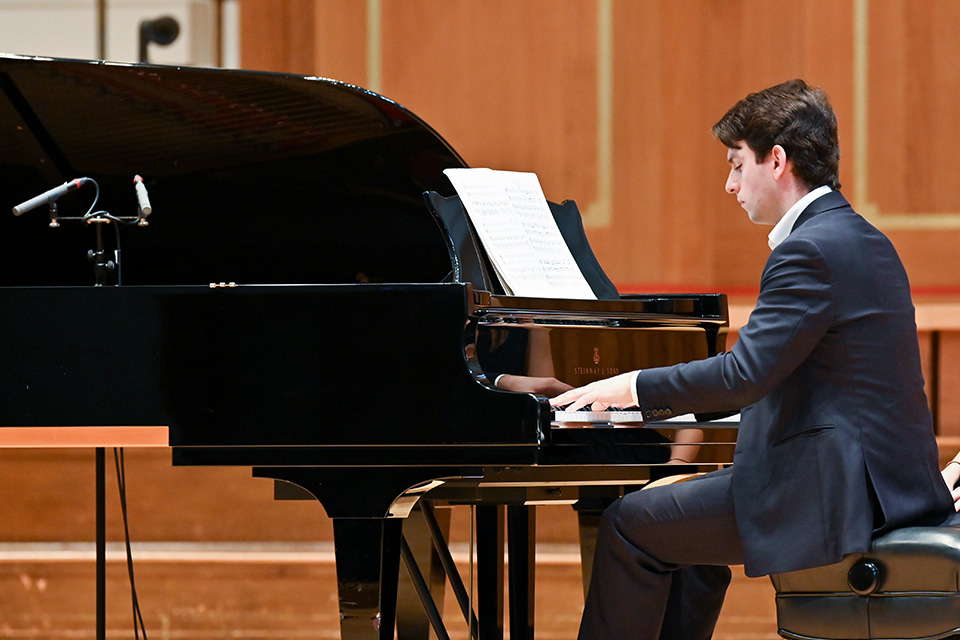 A pianist performs on stage in the Amaryllis Fleming Concert Hall
