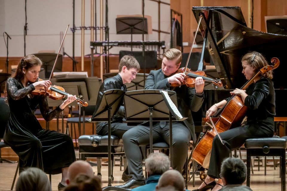 A string quartet performs on stage