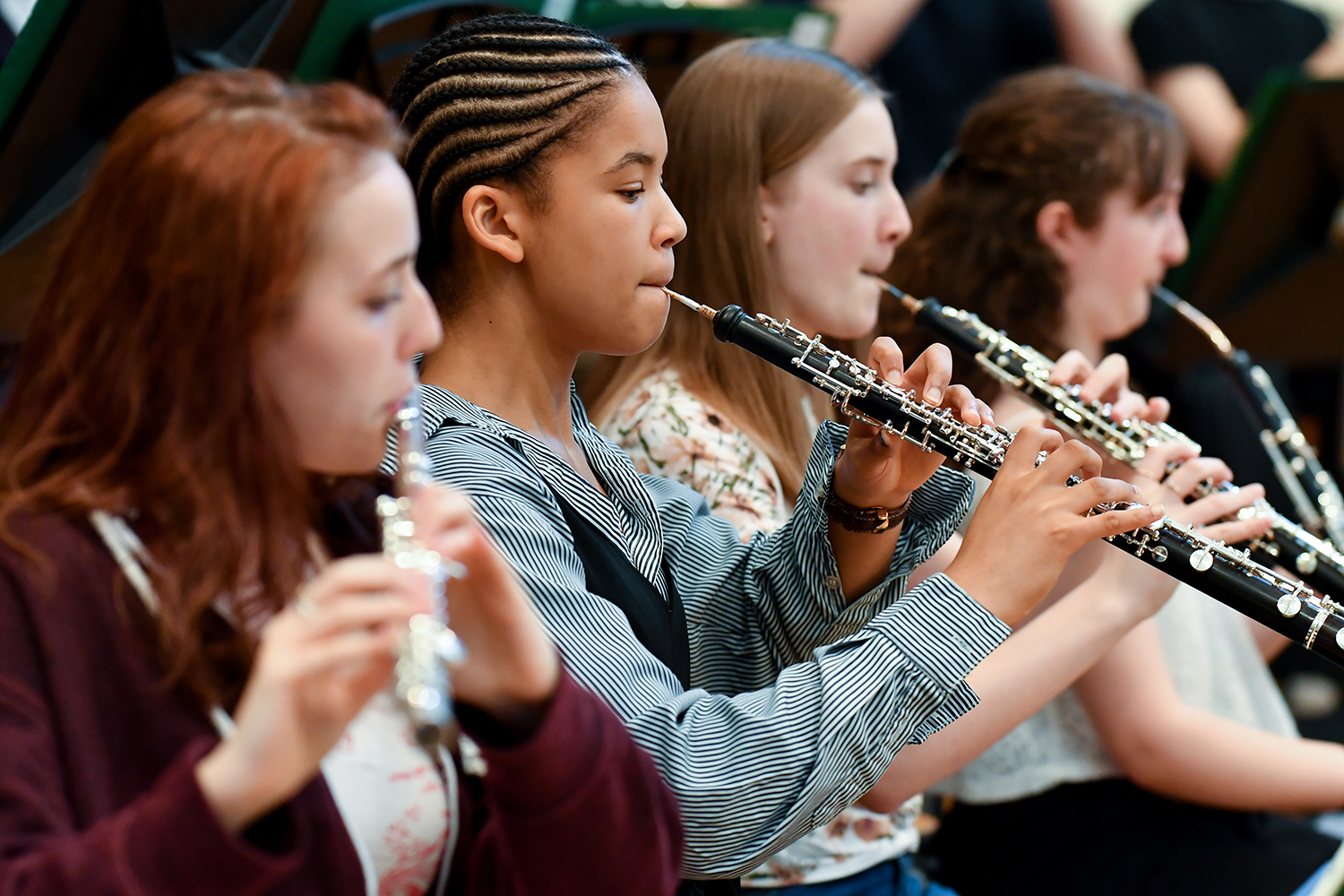 A row of musicians in the RCM Junior Department performing on oboes and the flute