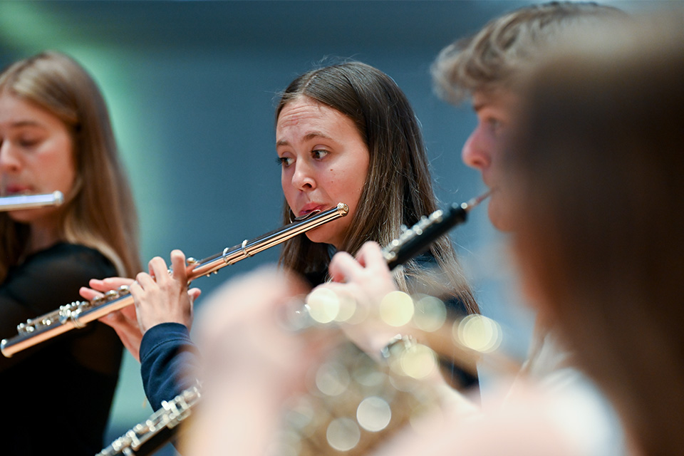 A flautist plays in a chamber group