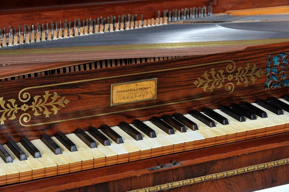 A close-up of piano keys on a 19th century square piano