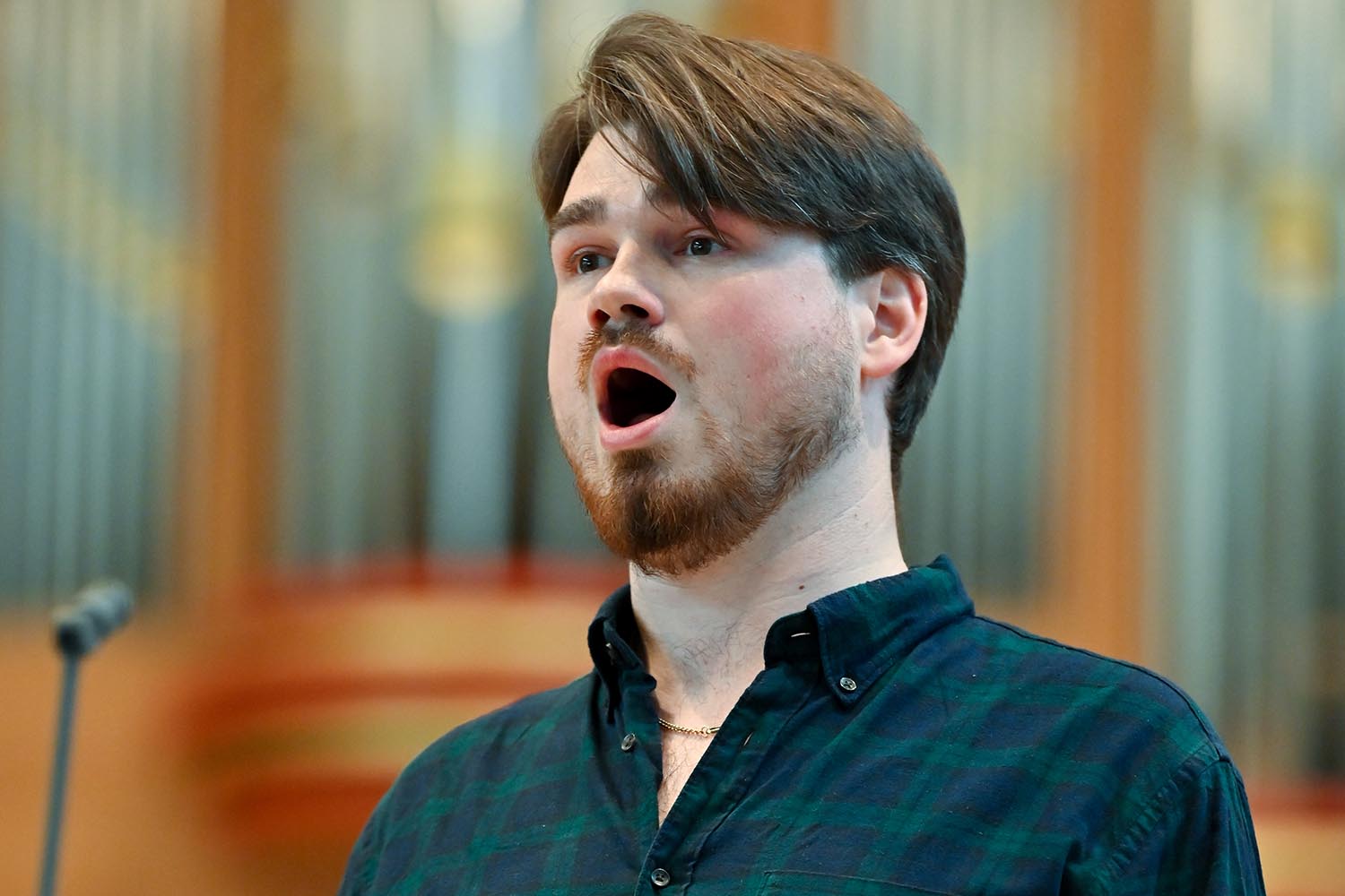 A close up image of a man singing