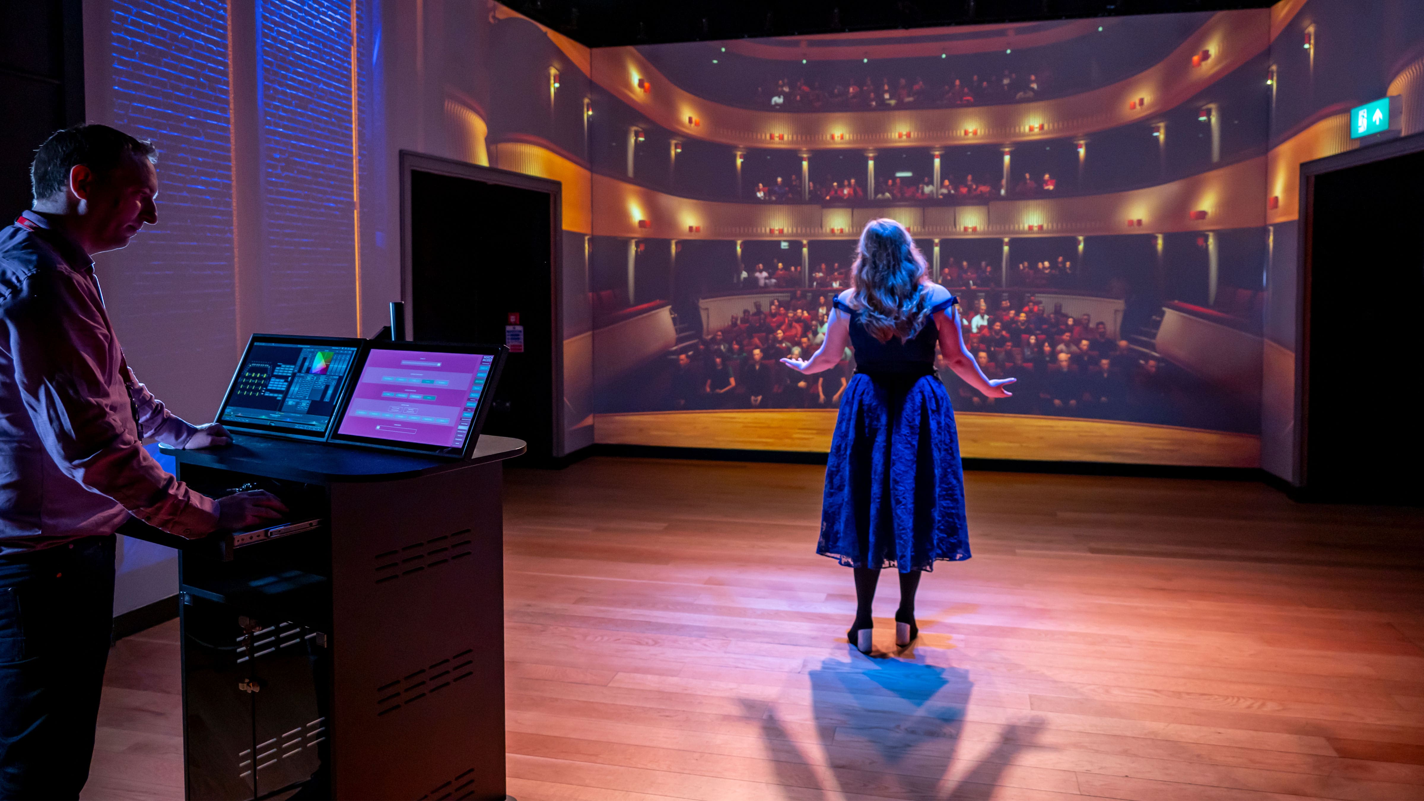 A vocal student and staff using the Performance Simulator