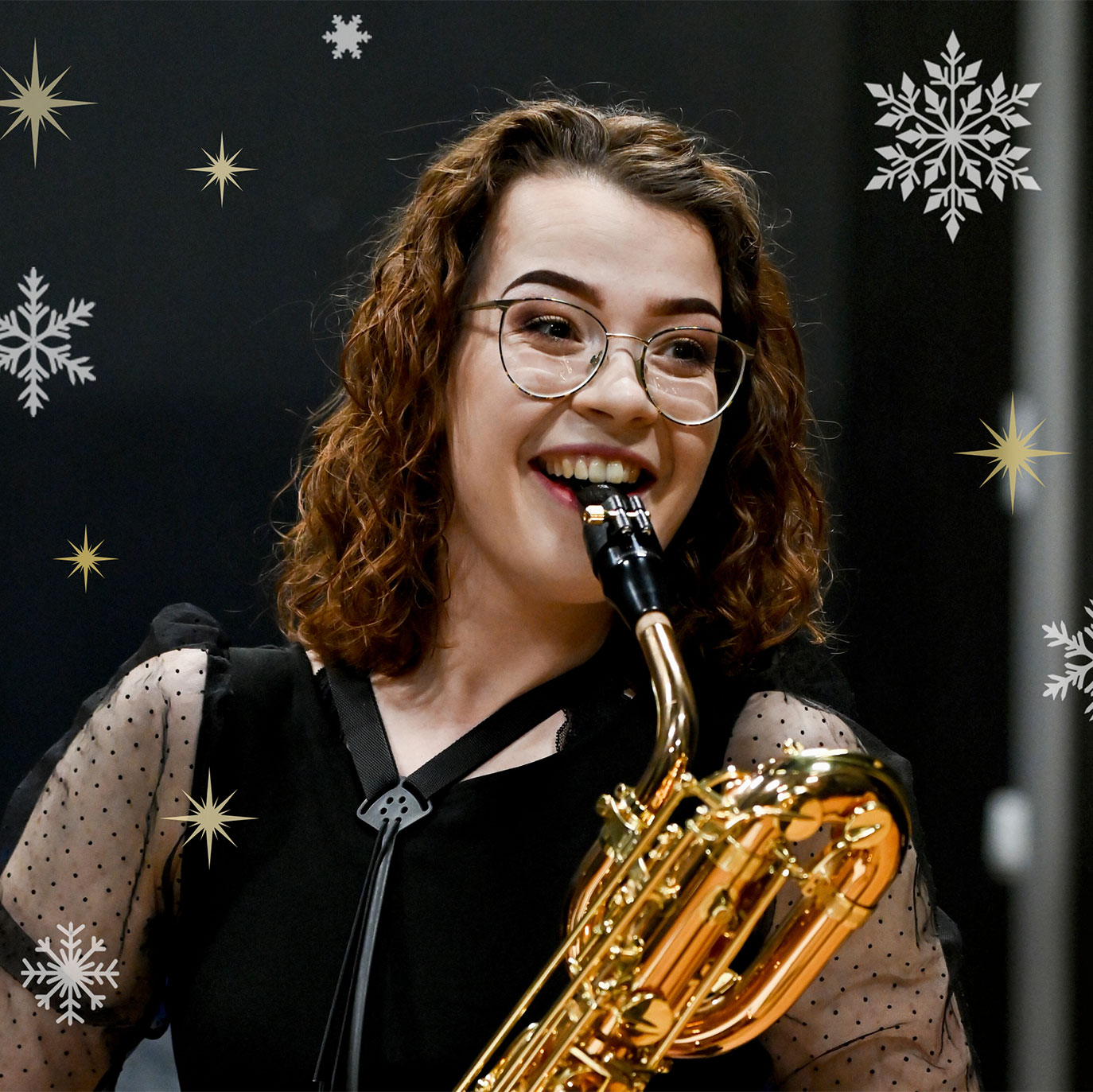 A female saxophonist, smiling